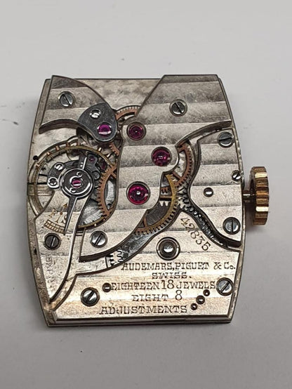 1937 Audemars Piguet Cintrée wristwatch in yellow gold with elongated curved lugs, signed dial and movement – rare vintage design.